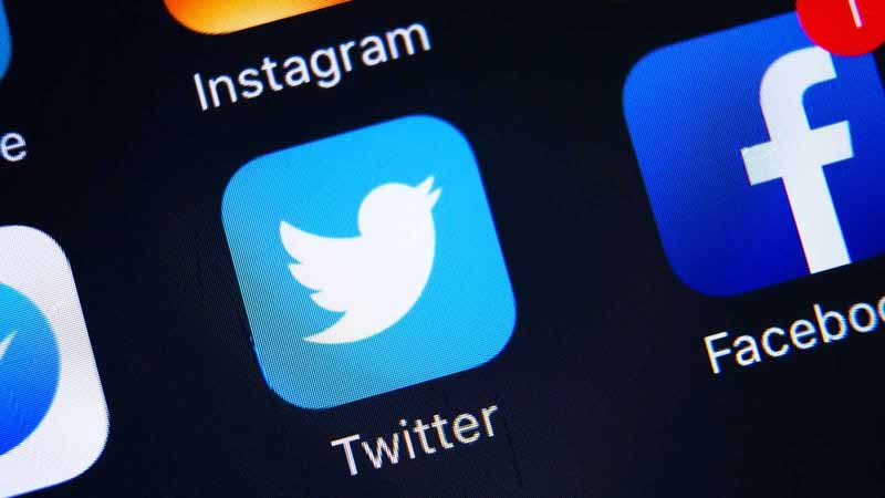 Closeup of Twitter, Facebook, Snapchat, and Instagram on a smartphone.